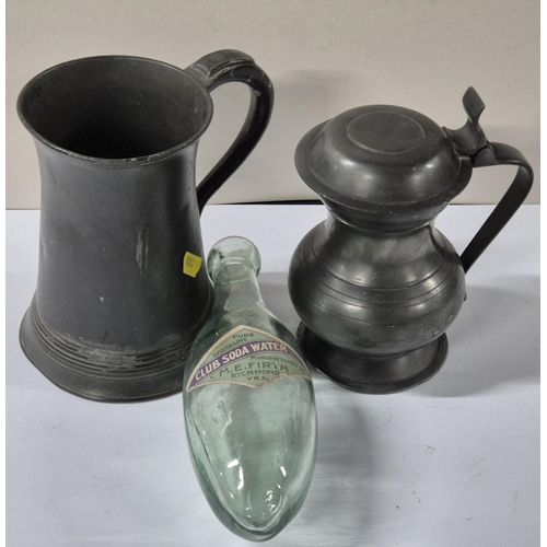 99 - Two antique pewter tankards together with an old, labeled club soda bottle (3)