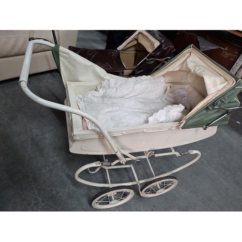 569 - Two mid 20thC, large metal doll prams (2)