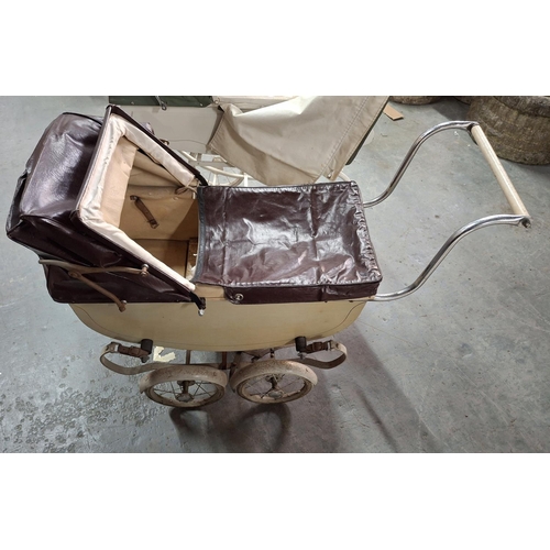 569 - Two mid 20thC, large metal doll prams (2)