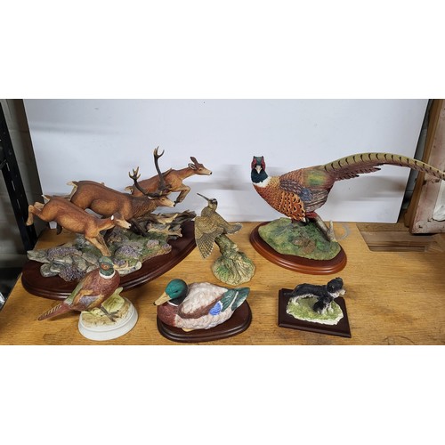 393 - Collection of ceramic animals on plinths (Qty)