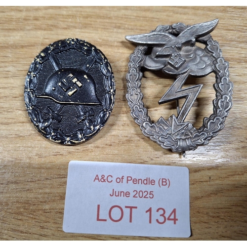 134 - Two vintage but replica German WWII cap badges (2)