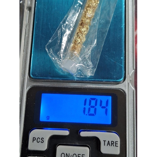 228 - Small glass vial filled with gold coloured flakes, supposedly Gold.

Please note - Totally untested
... 