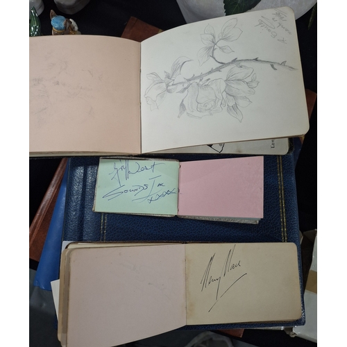 Three autograph books containing mid 20thC autographs, largely ...