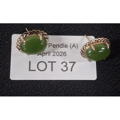 37 - Pair of ovel Jade earrings set in unmarked gold coloured metal settings