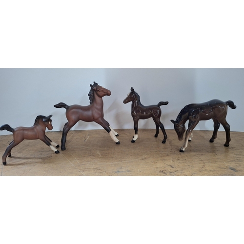39 - Two Beswick matt foals together with two Beswick bisque foals (4)