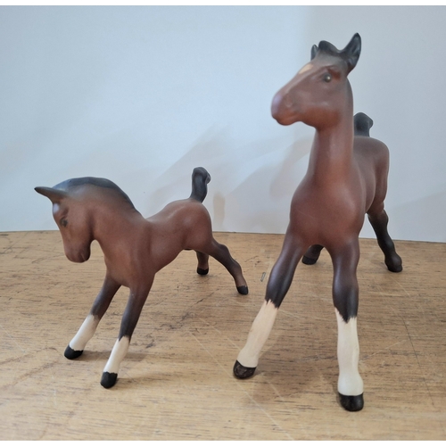 39 - Two Beswick matt foals together with two Beswick bisque foals (4)