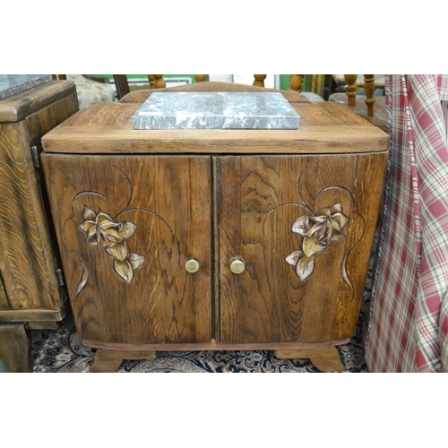 301 - Marble topped carved fronted oak cupboard w54cm x d30cm x h50cm