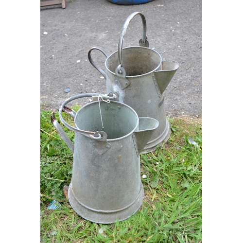 23 - Two galvanised pitchers , one A/F