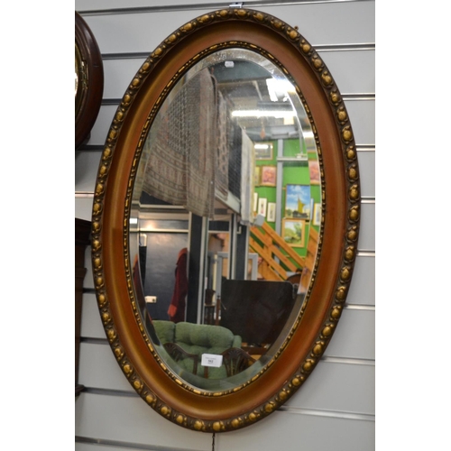 562 - Oval bevelled gilt framed mirror