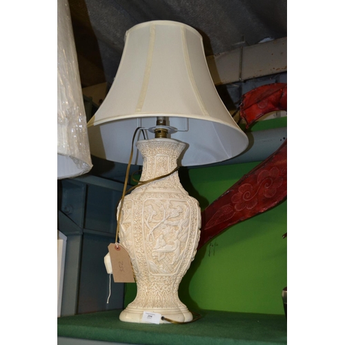 254 - Oriental style table lamp with decorative relief