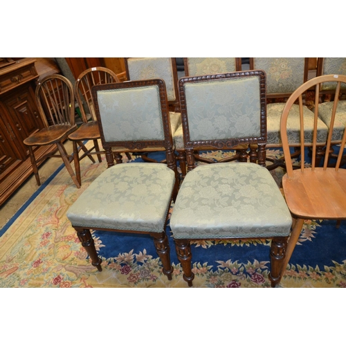 879 - Pair of oak framed carved dining chairs, on tapered ring-turned legs