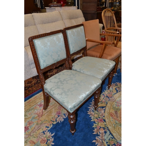 879 - Pair of oak framed carved dining chairs, on tapered ring-turned legs