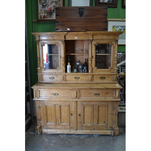 236 - Stripped pine column featured glass fronted dresser. Comprised of 4 doors & 5 drawers. W149cm H178cm