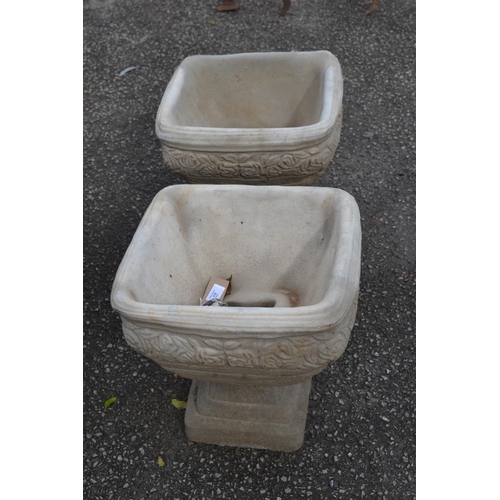 115 - Pair of square urns on stepped base, with rose frieze relief