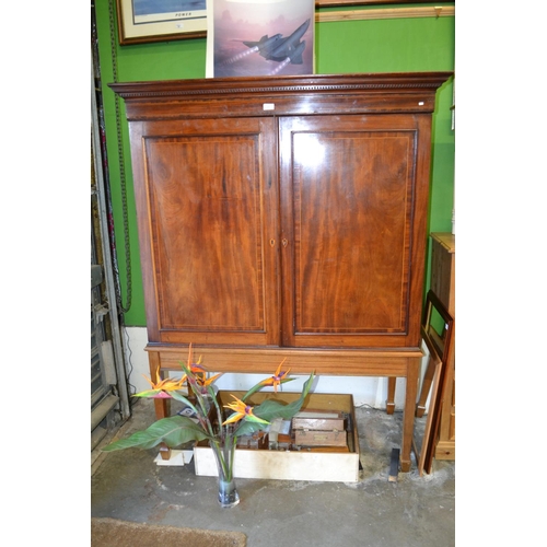 636 - Mahogany linen press with inlaid marquetry on stand. H172cm W120cm