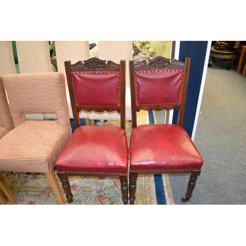 712 - Pair of vintage dining chairs, with cushioned seats on casters