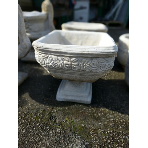 166 - Pair of square urns on stepped base, with rose frieze relief