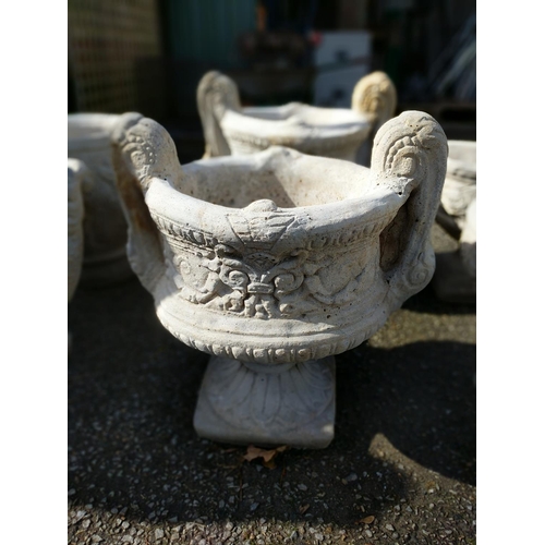 168 - Large handled urn on fluted square base with a chasing floral relief to sides