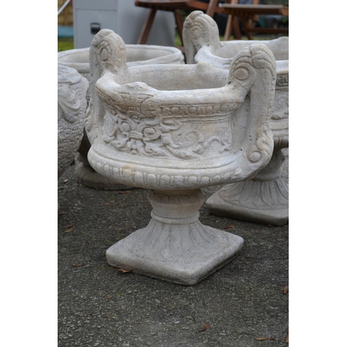 167 - Large handled urn on fluted square base with a chasing floral relief to sides