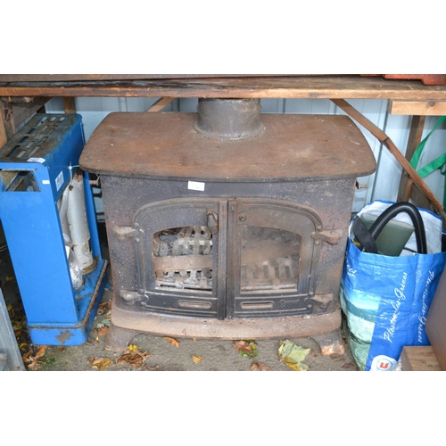 86 - Large 12kw multi-fuel burning stove. Accessories inside. Glass replacement & service required before... 