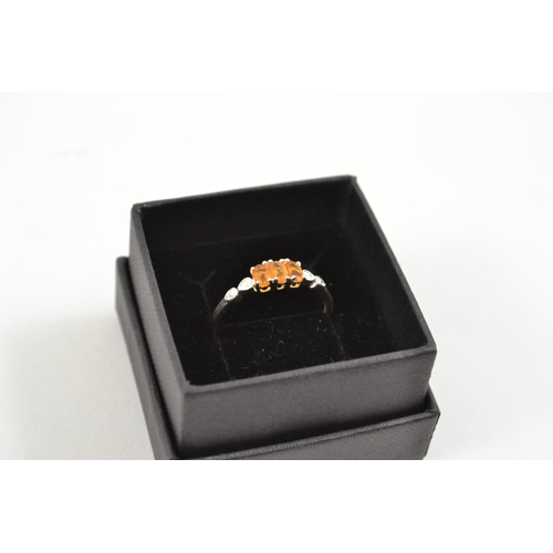 598 - Silver dress ring with orange stones