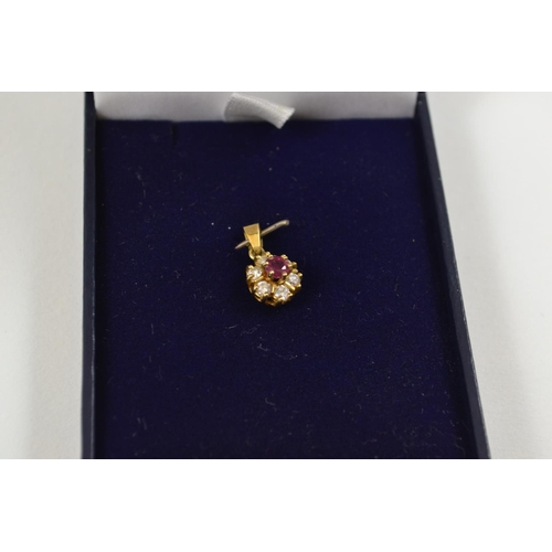 642 - 18ct gold Ruby & diamond pendant. 9mm diameter.