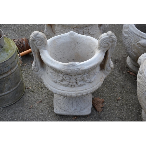 102 - Large handled urn on fluted square base with a chasing floral relief to sides