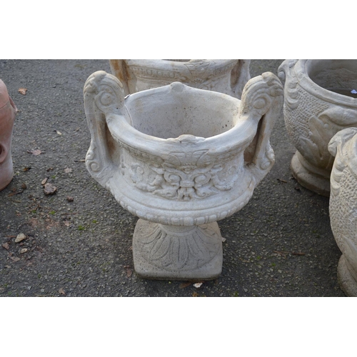 72 - Large handled urn on fluted square base with a chasing floral relief to sides