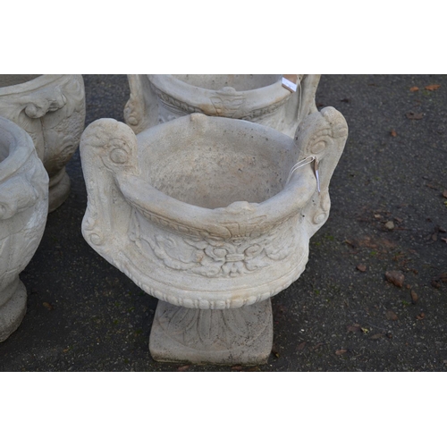 73 - Large handled urn on fluted square base with a chasing floral relief to sides