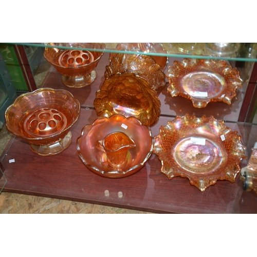 145 - Carnival glass items on bottom shelf