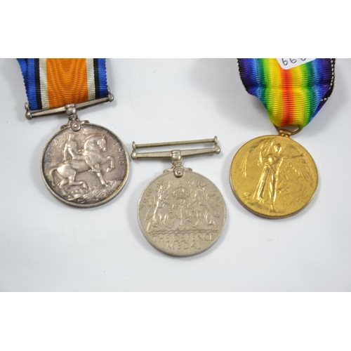 123 - WWI Pair of service medals (G. Wright, Royal Artillery) and a WWII Defence medal.