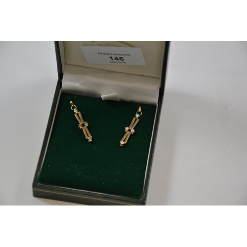 146 - An attractive pair of yellow metal, two tier diamond drop earrings