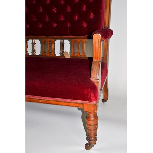 965 - Mahogany framed low sofa on castors, upholstered in a red velvet fabric, with button back detail. 13... 