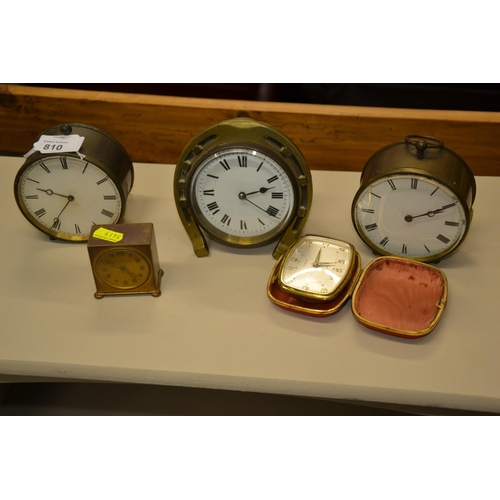 810 - 4 brass cased clocks + Europa travel clock