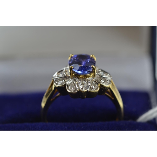 383 - 18ct gold, tanzanite & diamond cluster ring, size O