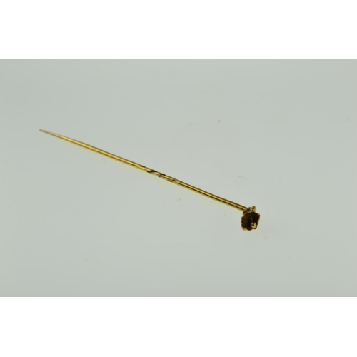 409 - Yellow metal stick pin with flower finial, tests positive for 9ct gold, 1.49 grams