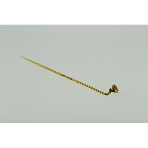 409 - Yellow metal stick pin with flower finial, tests positive for 9ct gold, 1.49 grams