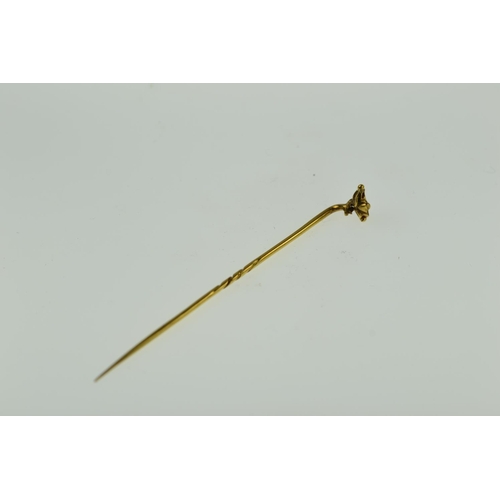 409 - Yellow metal stick pin with flower finial, tests positive for 9ct gold, 1.49 grams