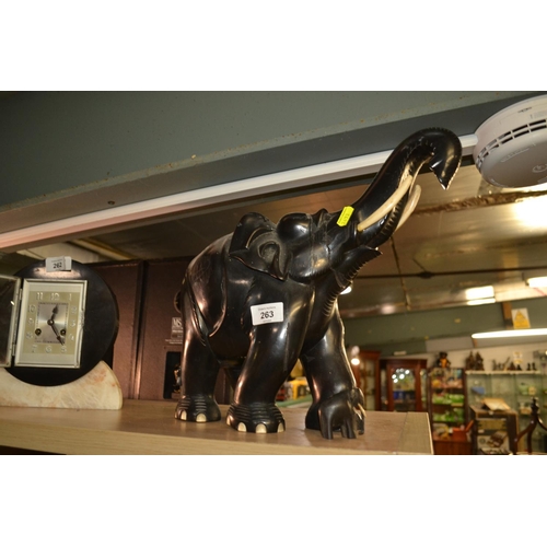 263 - Heavy, solid carved wood elephant, height to top of trunk 33cm, with tiny baby