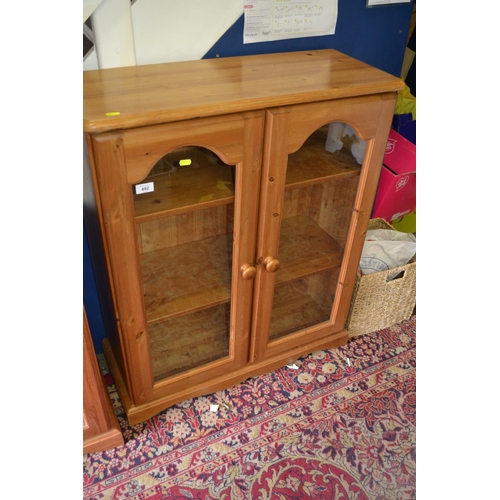 492 - Small 2 door glass fronted pine display cabinet. Width 80 CM. Height 96 CM.