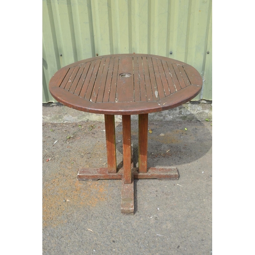 102 - Circular wooden garden table, 85cm diameter, wear to varnish