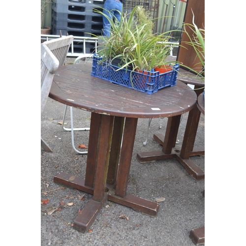 104 - Circular wooden garden table, 85cm diameter, wear to varnish