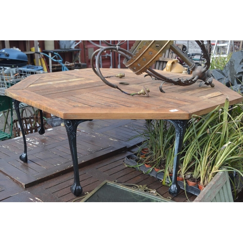 89 - Teak topped low garden coffee table on cast legs, diameter 119cm, height 42cm