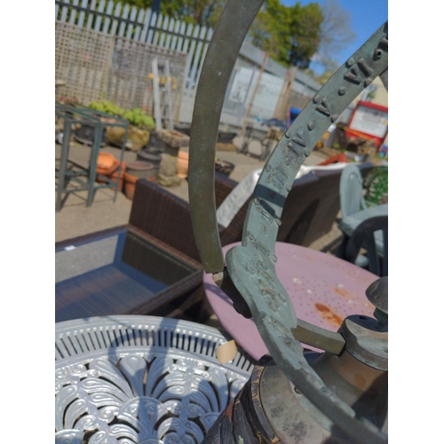 77 - Bronze equatorial sundial, mounted on pot. Broken arm to dial.