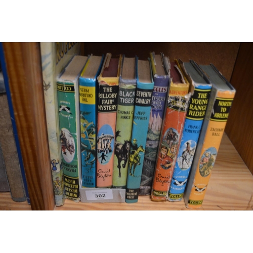 302 - Shelf of Children's adventure books, plus Rupert.