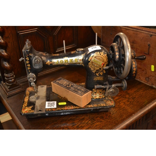 518 - Vintage Jones' sewing machine plus small box of sewing machine parts.