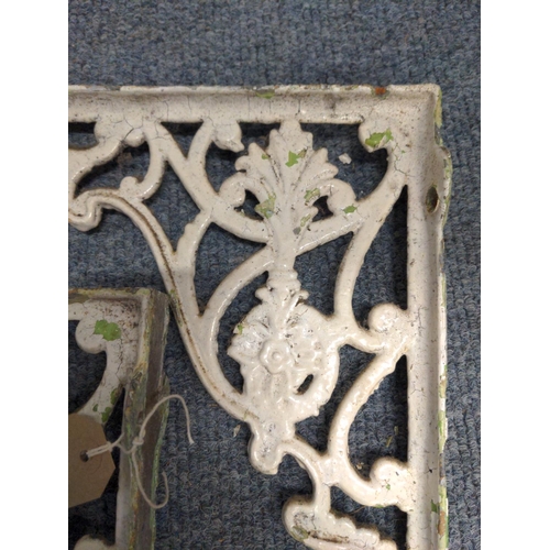 221 - Pair of ornate cast iron wall brackets.