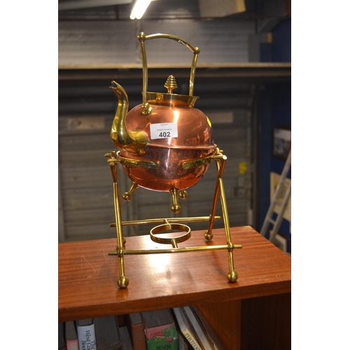 402 - Brass and copper kettle and stand.