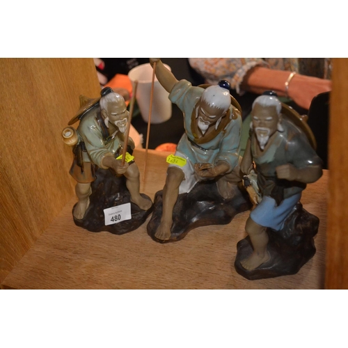 480 - Three stoneware mud men.