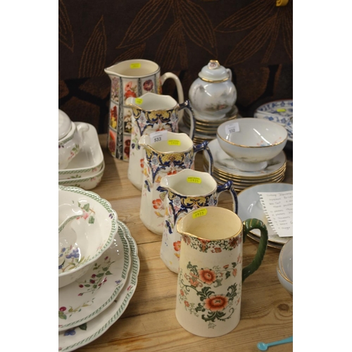 533 - Set of three graduated Matlock jugs, a Doulton Nankin pattern jug and another.